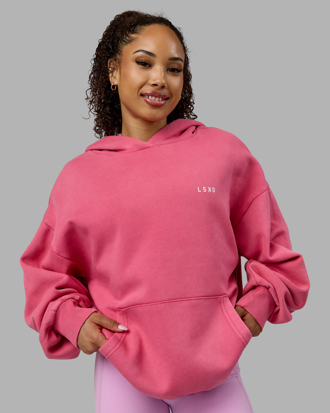 Woman wearing Unisex Washed Empower Hoodie Oversize - Berry Pink-Pastel Orchid