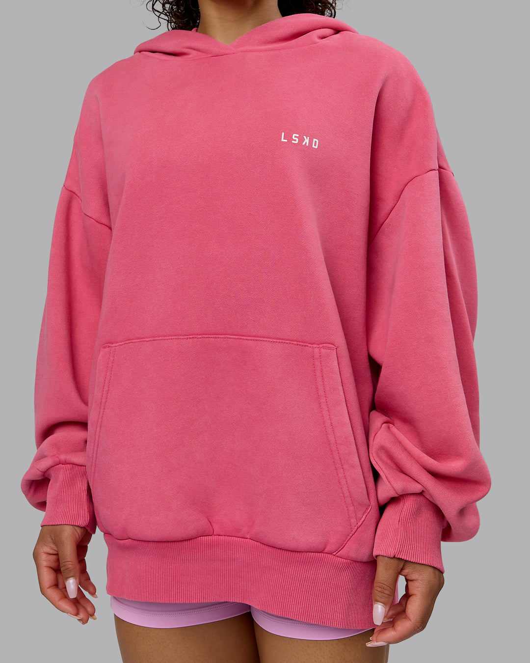 Woman wearing Unisex Washed Empower Hoodie Oversize - Berry Pink-Pastel Orchid