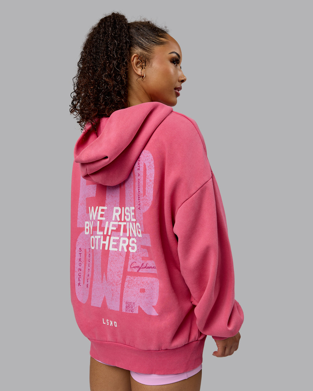 Woman wearing Unisex Washed Empower Hoodie Oversize - Berry Pink-Pastel Orchid