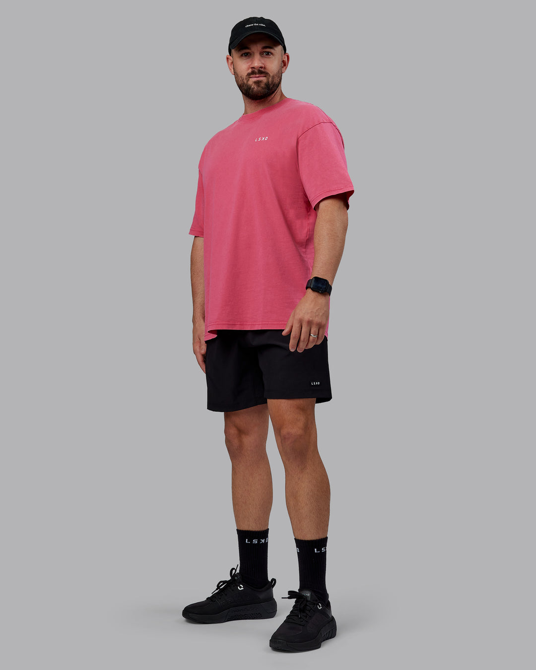 Man wearing Unisex Washed Empower Tee Oversize - Berry Pink-Pastel Orchid