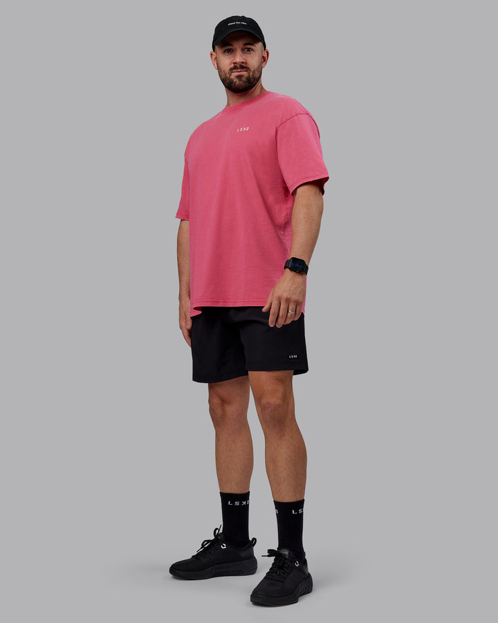 Man wearing Unisex Washed Empower Tee Oversize - Berry Pink-Pastel Orchid
