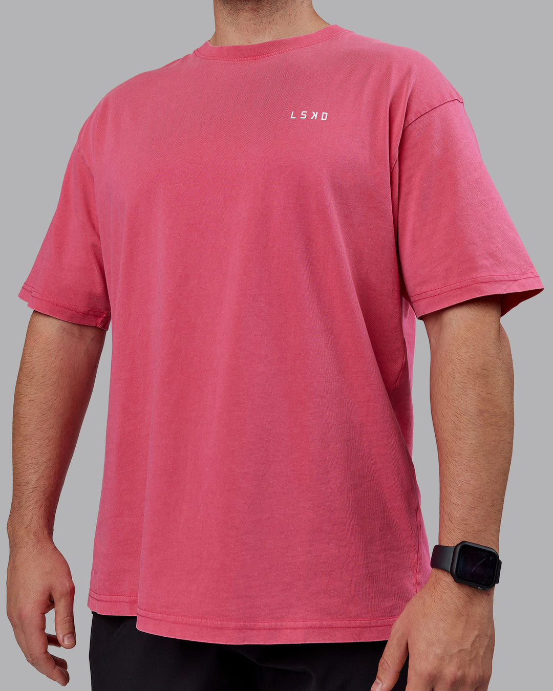 Man wearing Unisex Washed Empower Tee Oversize - Berry Pink-Pastel Orchid