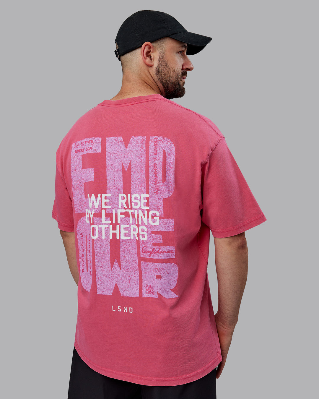 Man wearing Unisex Washed Empower Tee Oversize - Berry Pink-Pastel Orchid