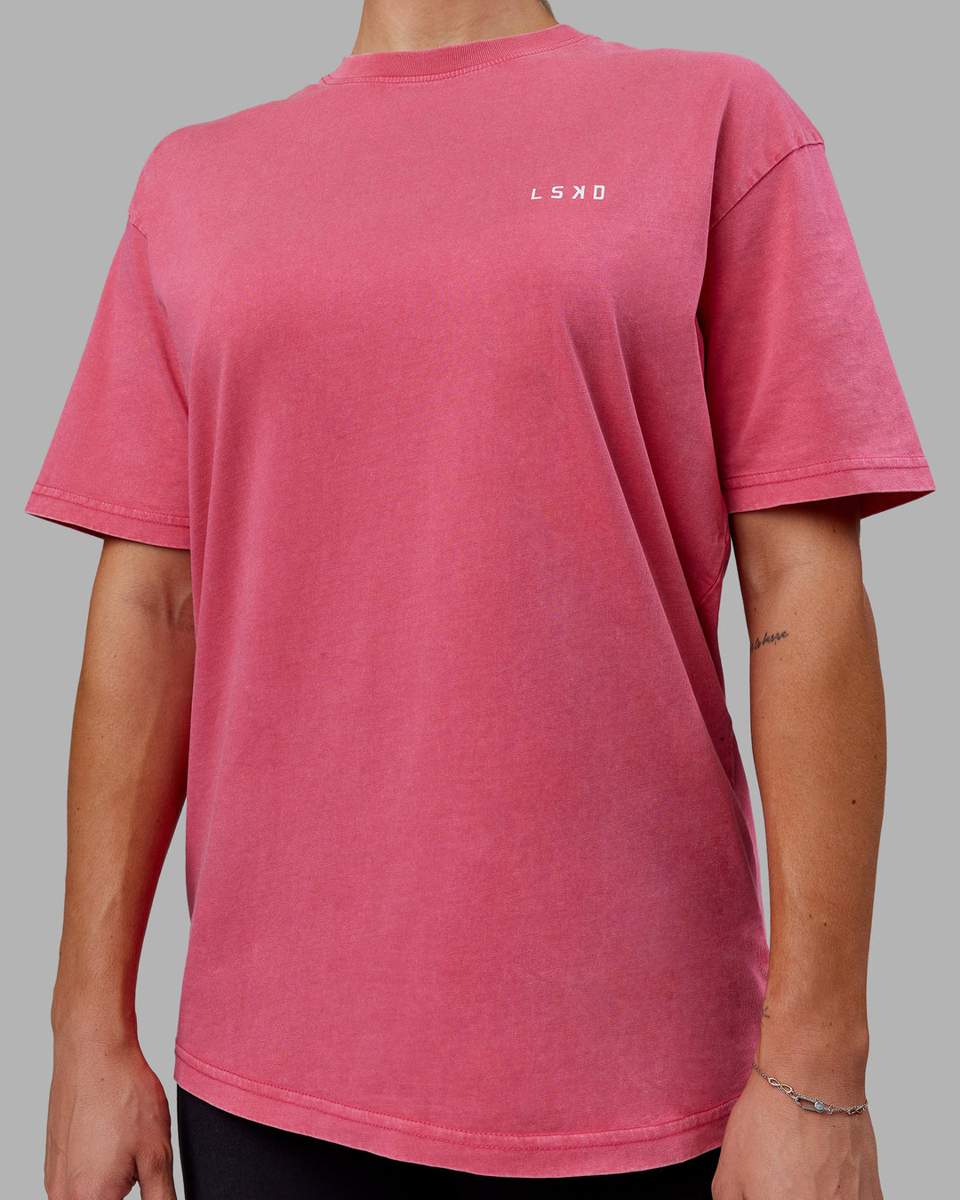 Woman wearing Unisex Washed Empower Tee Oversize - Berry Pink-Pastel Orchid