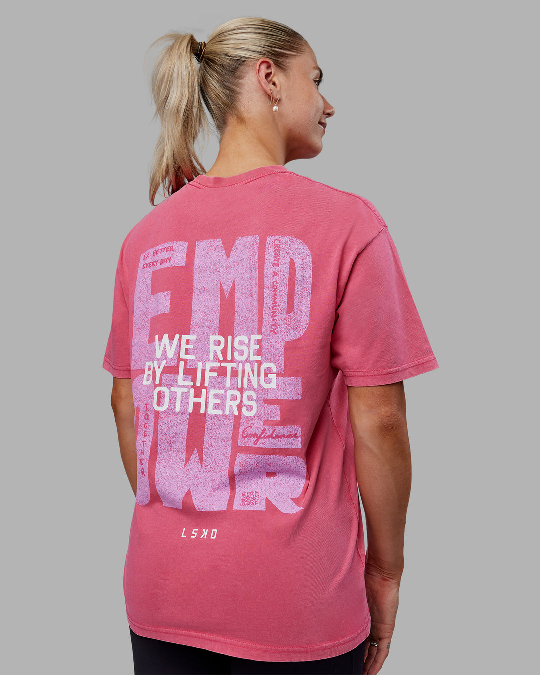 Woman wearing Unisex Washed Empower Tee Oversize - Berry Pink-Pastel Orchid