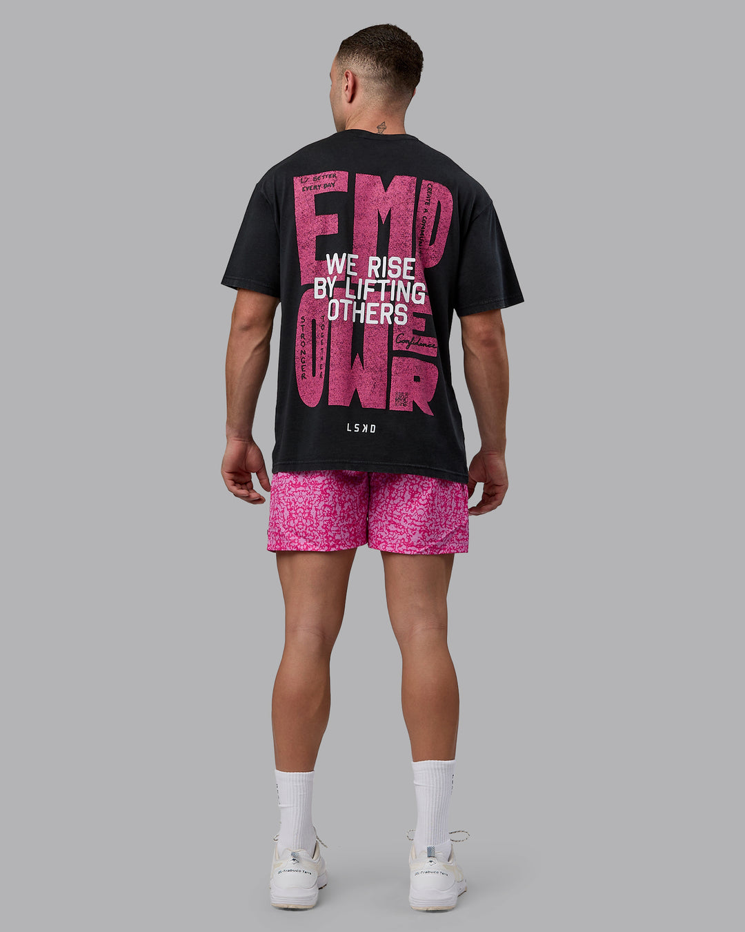 Man wearing Unisex Washed Empower Tee Oversize - Black-Berry Pink