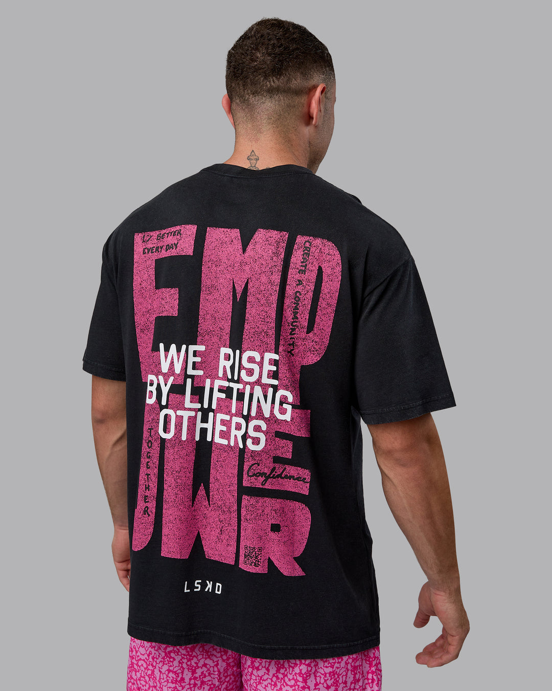 Man wearing Unisex Washed Empower Tee Oversize - Black-Berry Pink