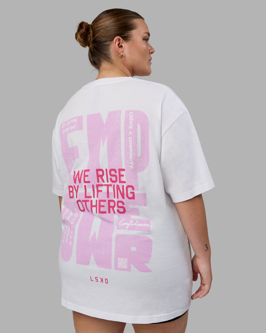 Woman wearing Unisex Washed Empower Tee Oversize - White-Pastel Orchid