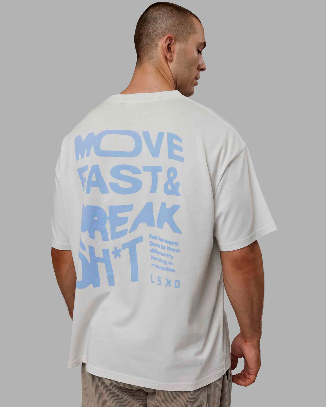 Man wearing Unisex Washed Move Fast Heavyweight Tee Oversize - Lunar Rock-Windsurfer