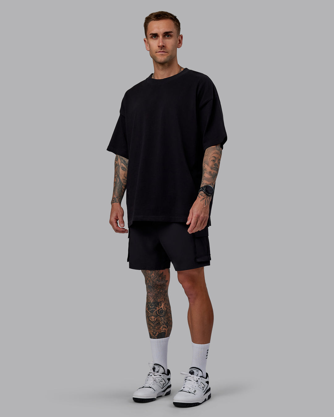 Man wearing Unisex We Rise Heavyweight Tee Oversize - Black-Impact Green