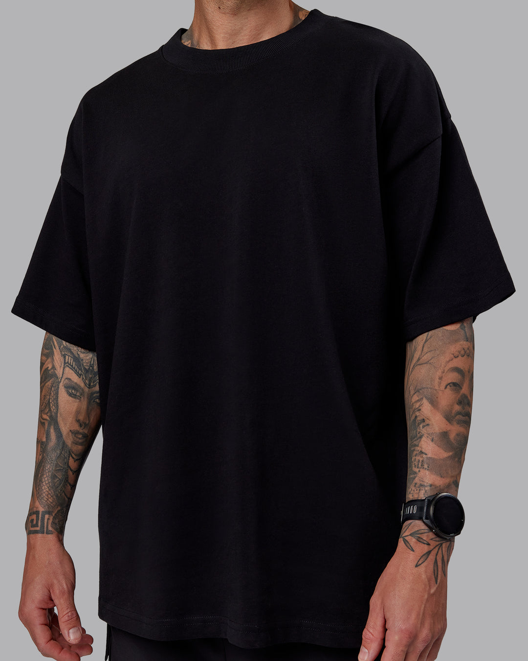 Man wearing Unisex We Rise Heavyweight Tee Oversize - Black-Impact Green