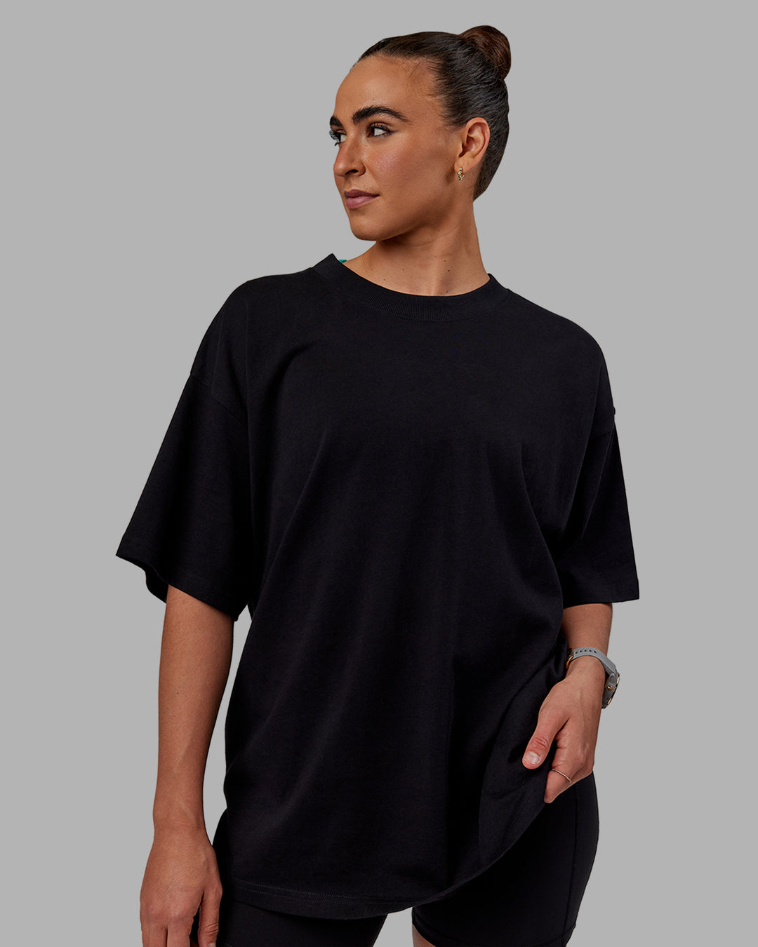 Woman wearing Unisex We Rise Heavyweight Tee Oversize - Black-Impact Green