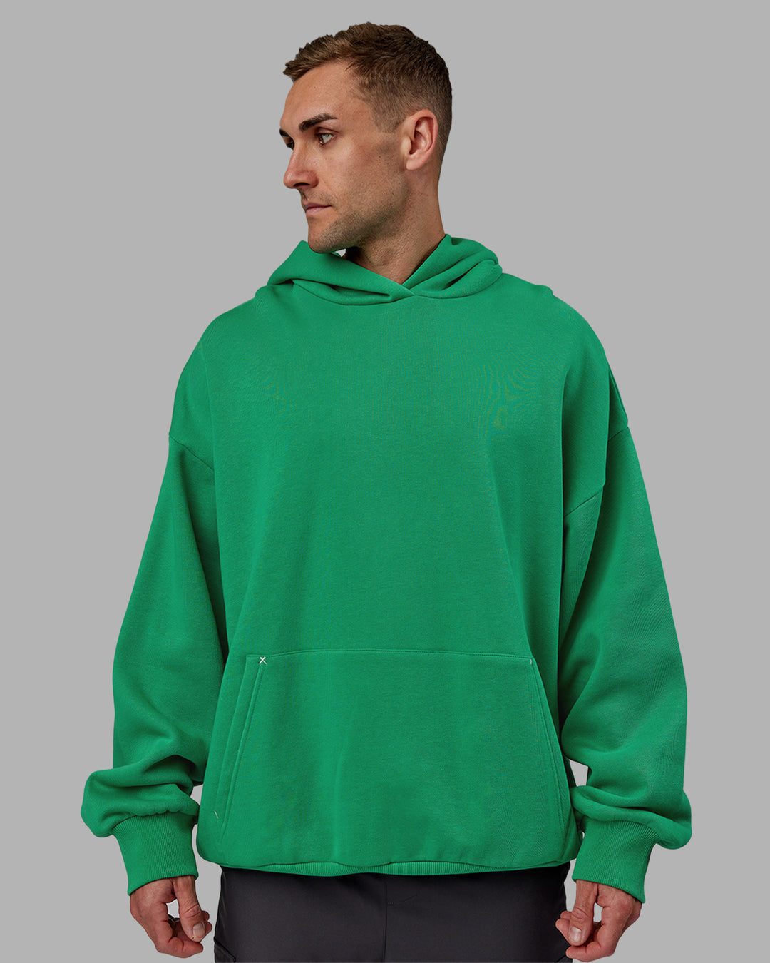 Man wearing Unisex We Rise Hoodie Oversize - Impact Green-White