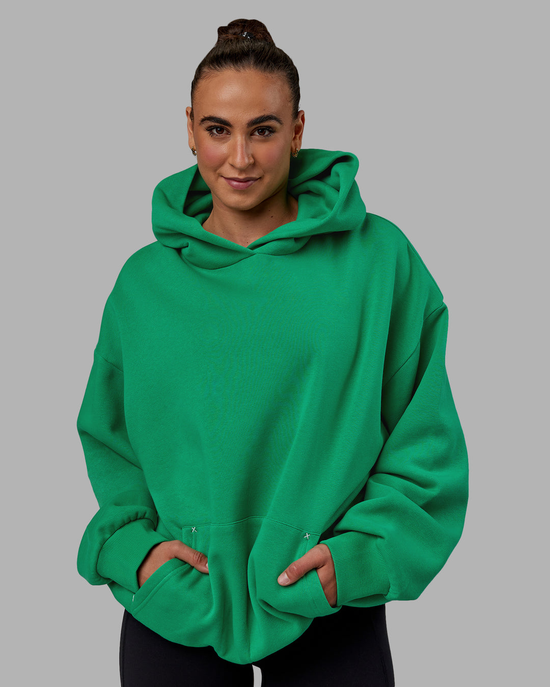 Woman wearing Unisex We Rise Hoodie Oversize - Impact Green-White