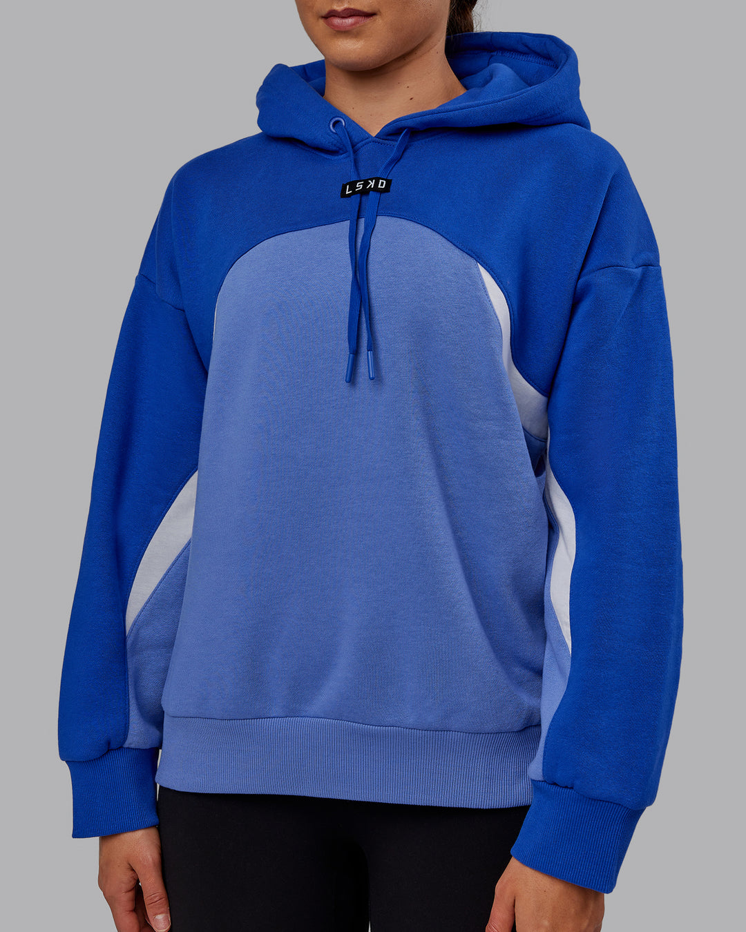 Woman wearing Unisex Y2K Concept Panel Hoodie - Power Cobalt-White