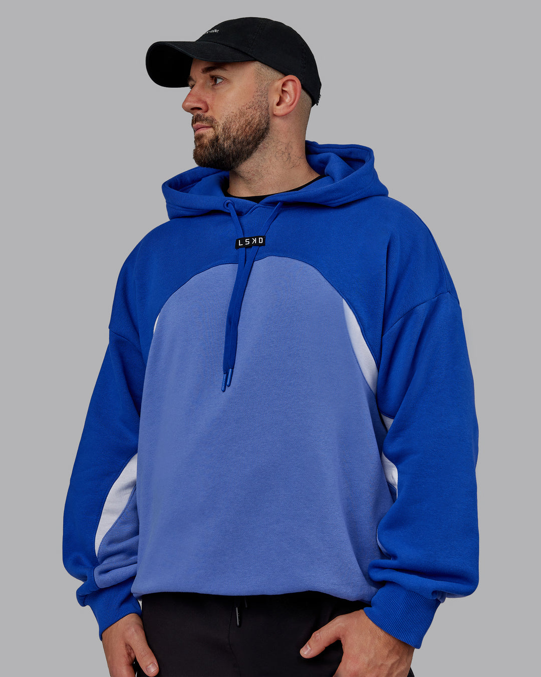 Man wearing Unisex Y2K Concept Panel Hoodie - Power Cobalt-White