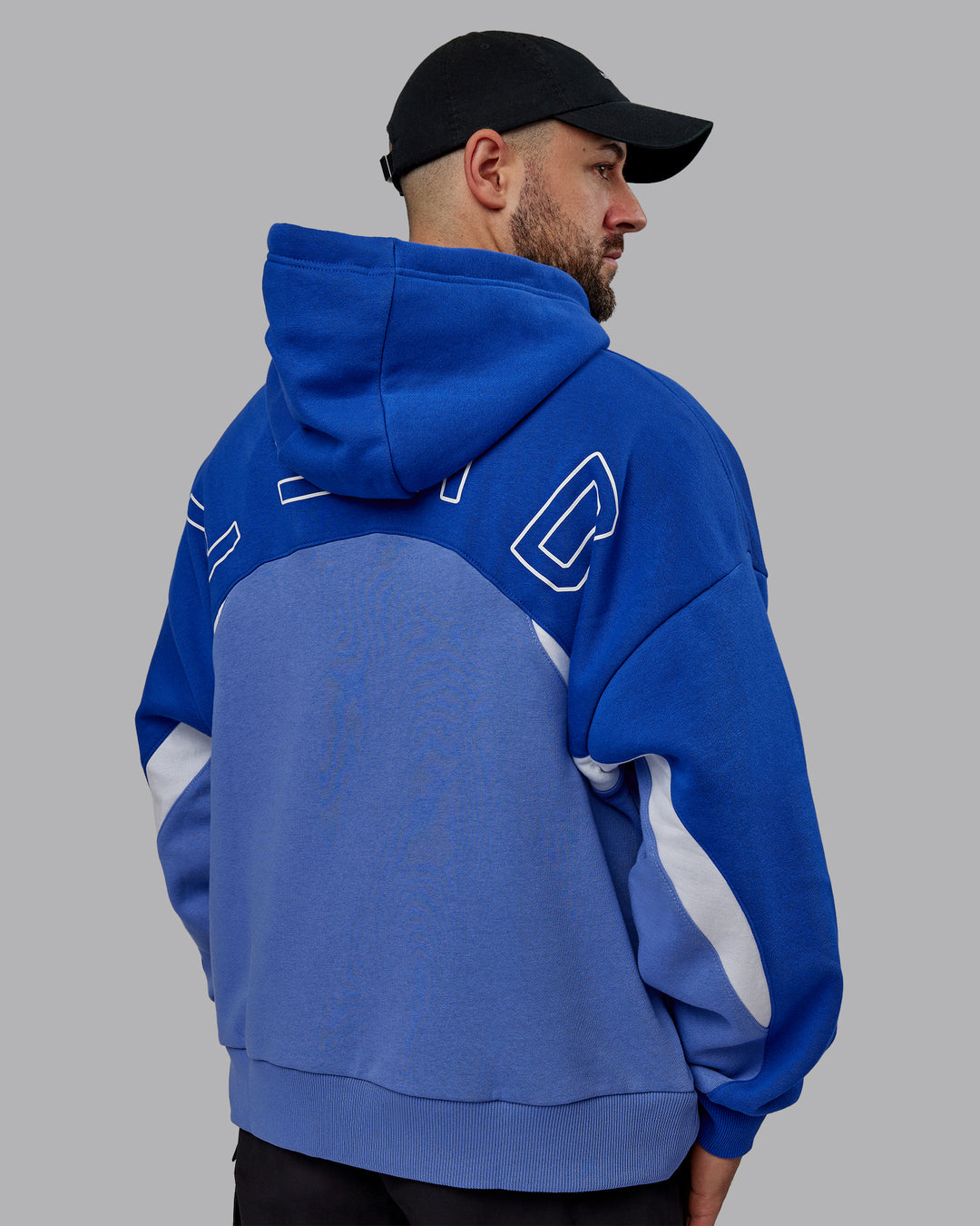 Man wearing Unisex Y2K Concept Panel Hoodie - Power Cobalt-White