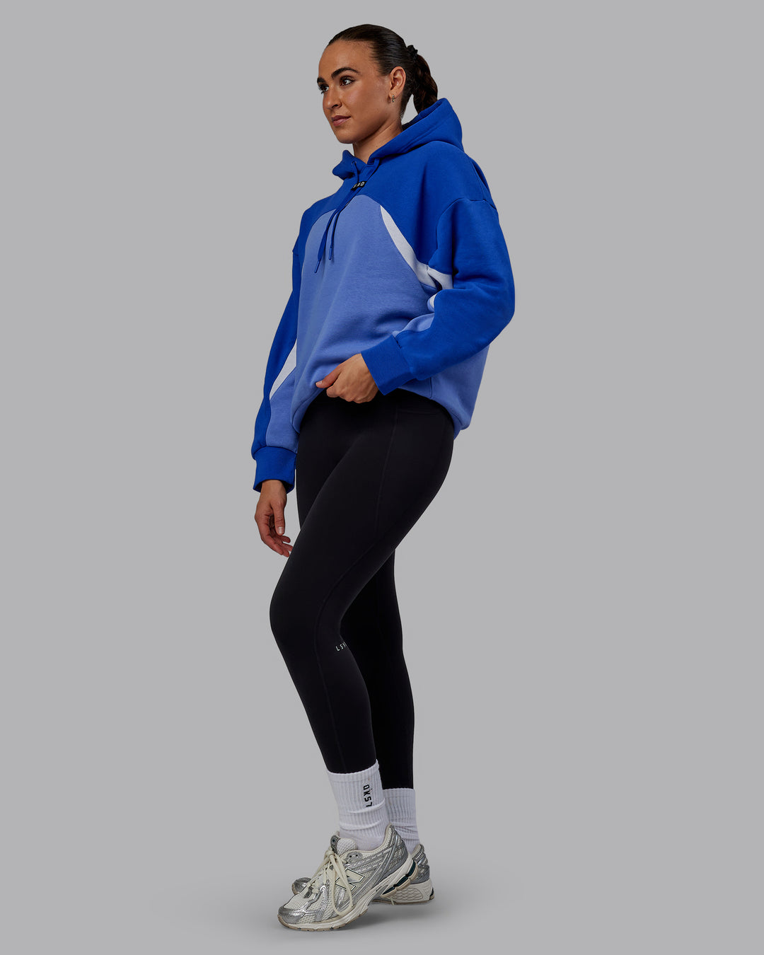 Woman wearing Unisex Y2K Concept Panel Hoodie - Power Cobalt-White