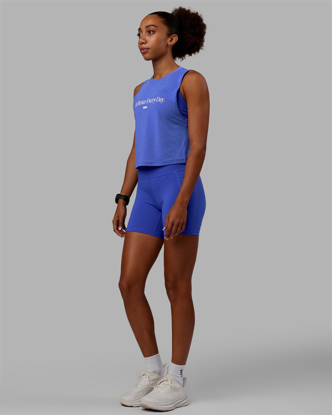 Woman wearing Vital 1% Better Cropped Training Tank - Power Cobalt Marl-White