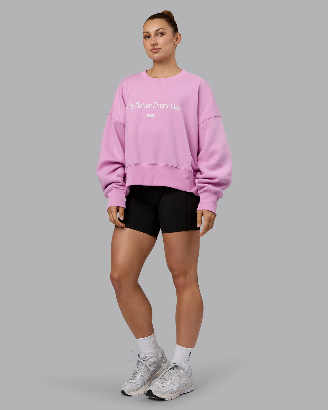 Woman wearing 1% Better Heavyweight Sweater - Pastel Orchid-White