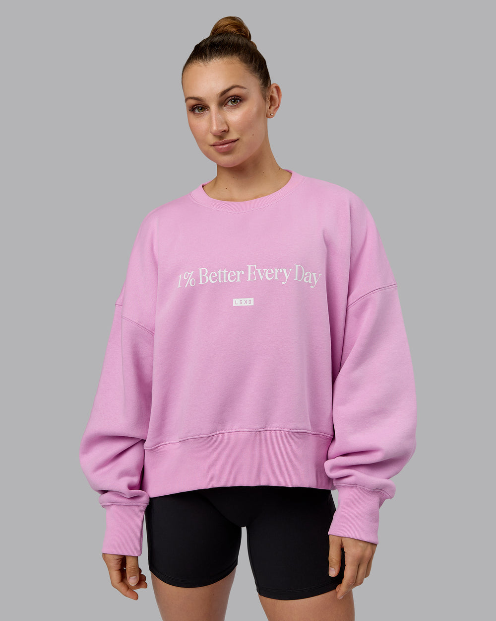 Woman wearing 1% Better Heavyweight Sweater - Pastel Orchid-White