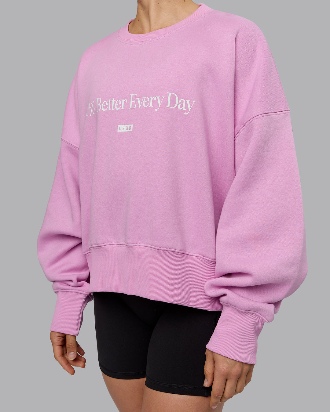 Woman wearing 1% Better Heavyweight Sweater - Pastel Orchid-White