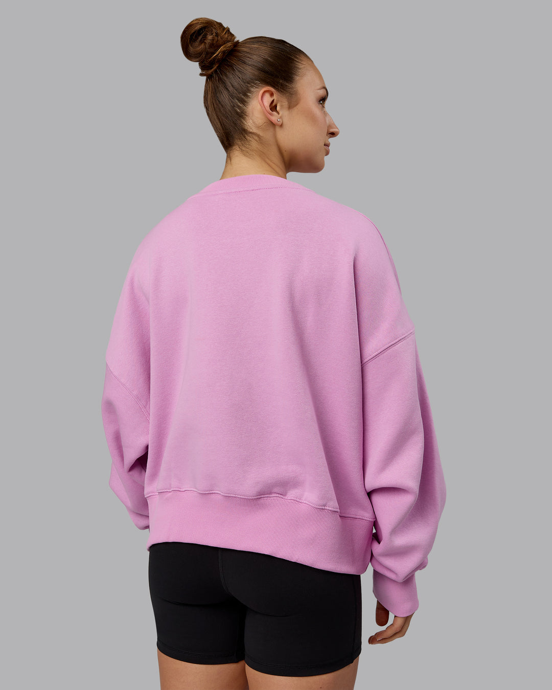 Woman wearing 1% Better Heavyweight Sweater - Pastel Orchid-White