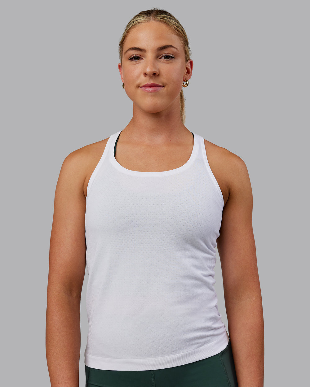 Woman wearing AeroFLX+ Seamless Tank - White