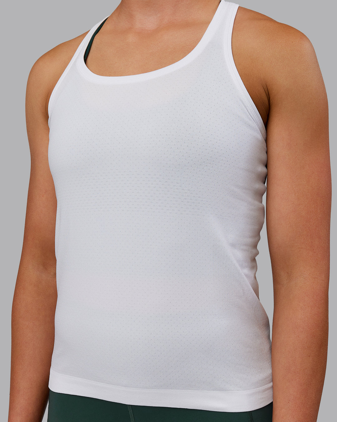 Woman wearing AeroFLX+ Seamless Tank - White