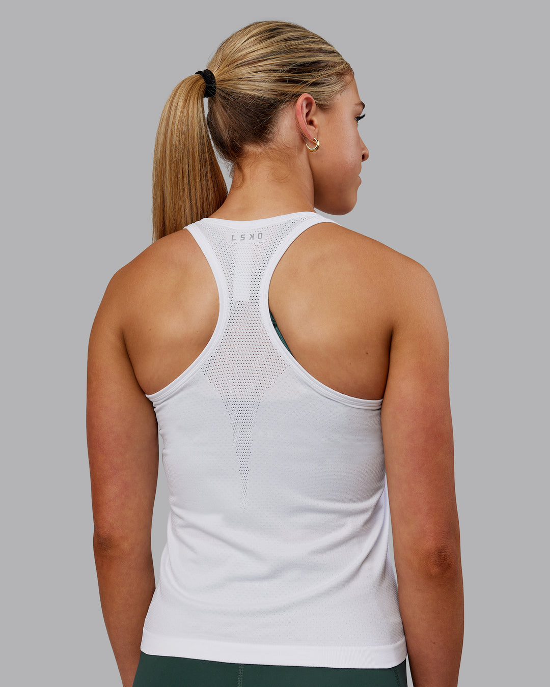 Woman wearing AeroFLX+ Seamless Tank - White