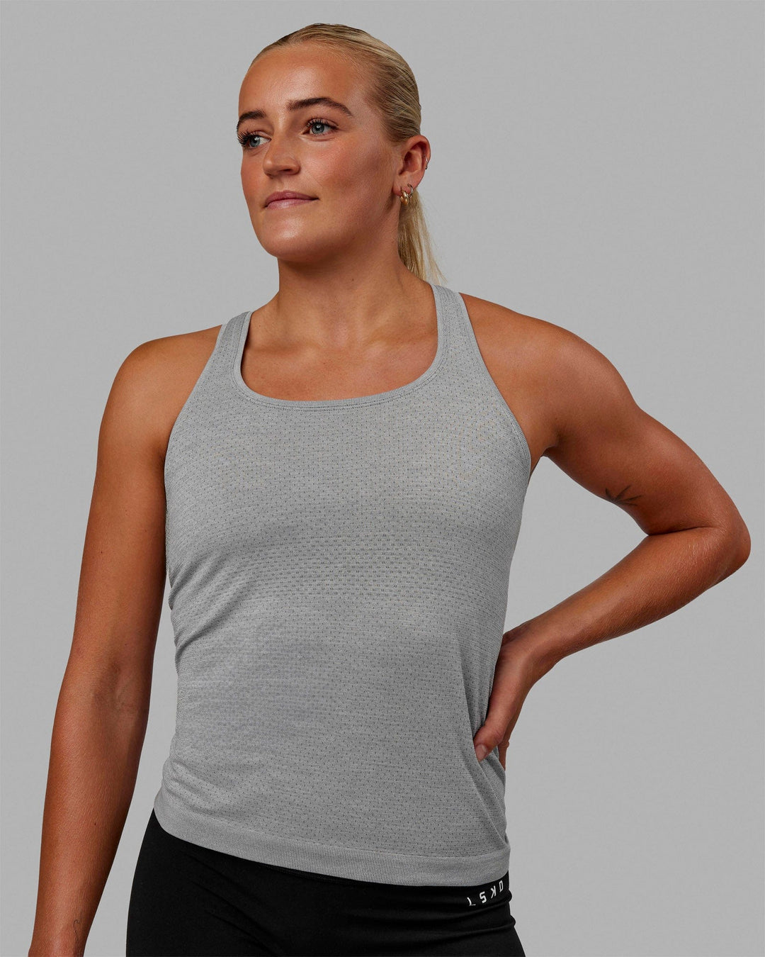 Woman wearing AeroFLX+ Seamless Tank - Light Grey Marl