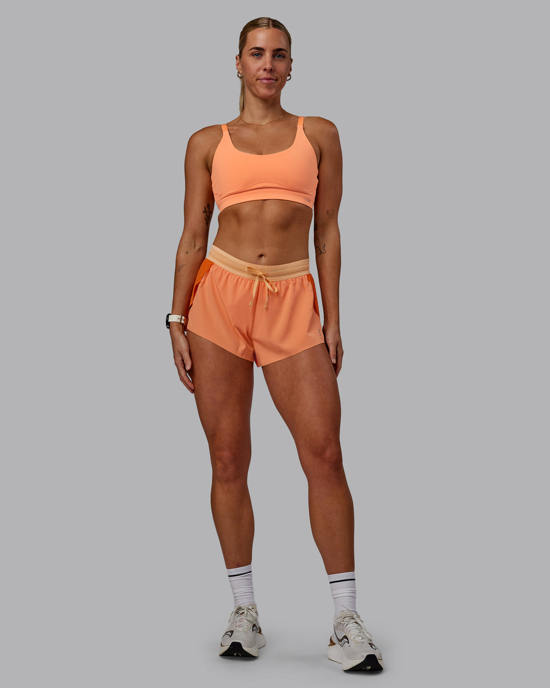 Woman wearing Accelerate 3&quot; Run Shorts - Cantaloupe Colourblock