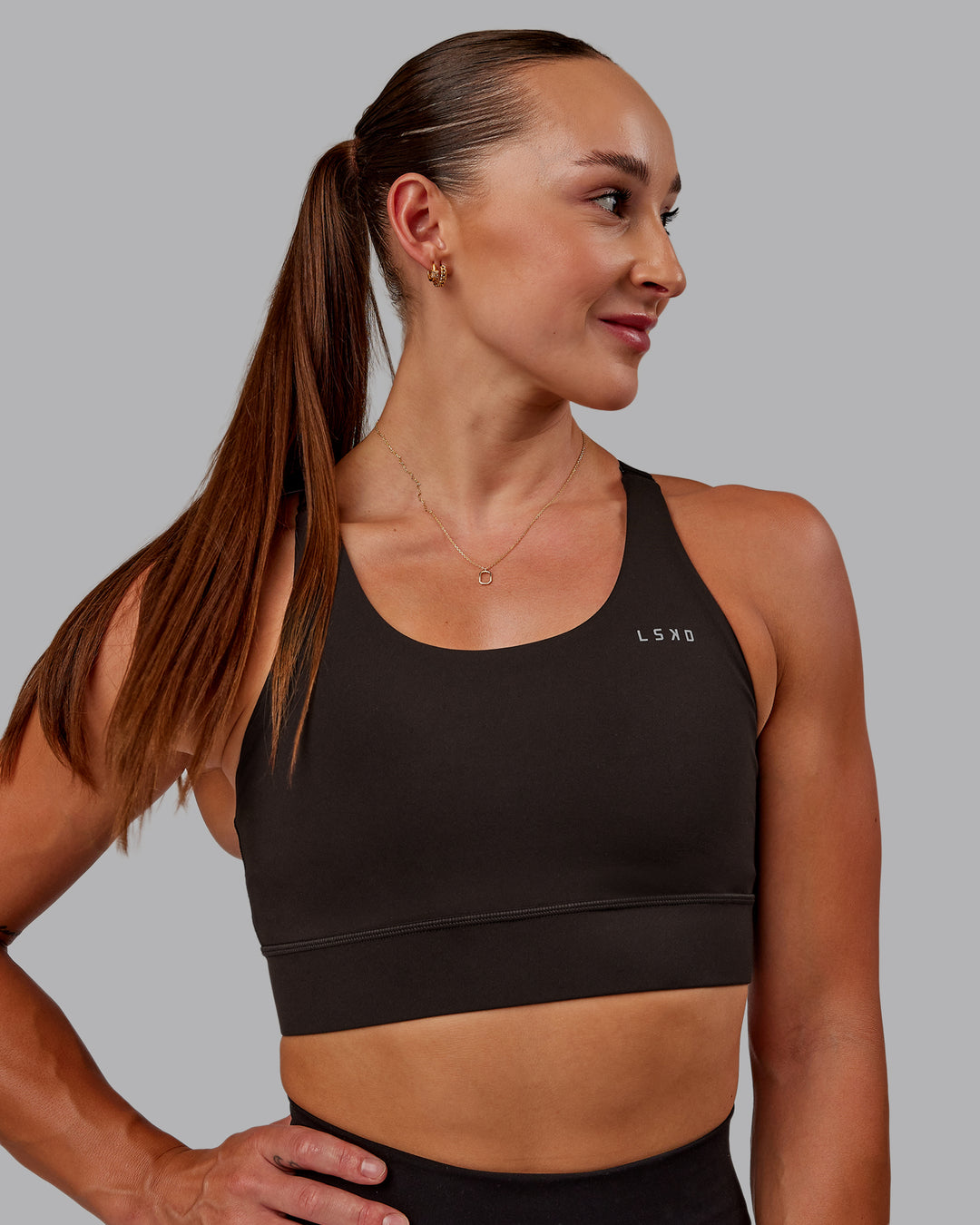 Woman wearing Accelerate Sports Bra in Dark Walnut | Size:S