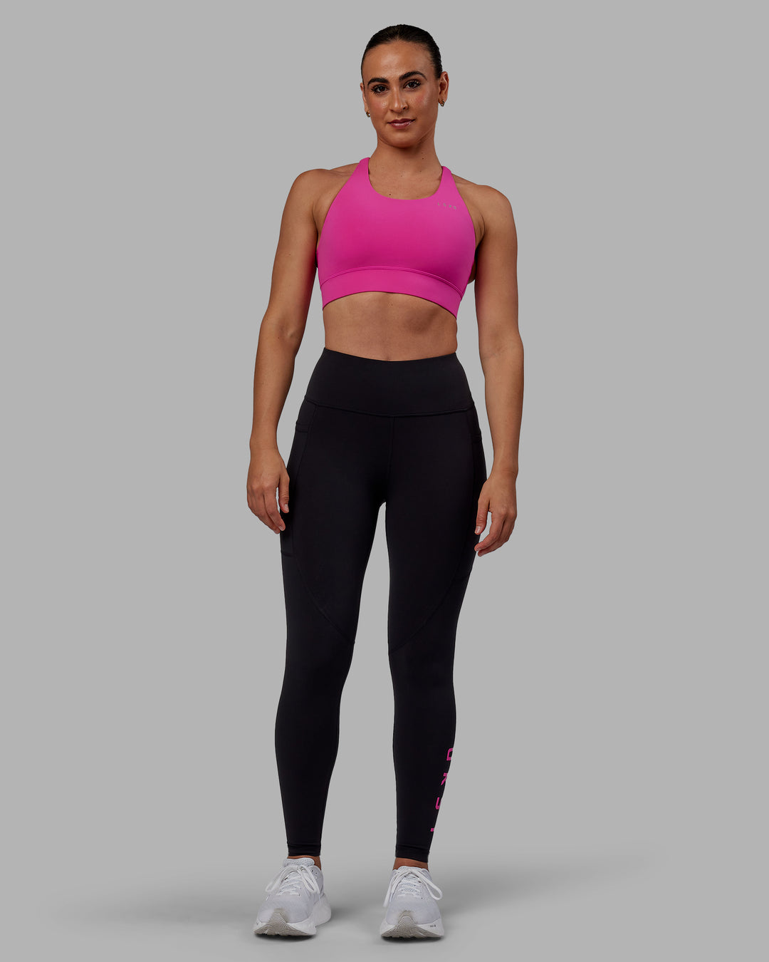 Woman wearing Accelerate Sports Bra - Fuchsia Pink