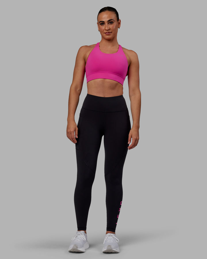 Woman wearing Accelerate Sports Bra - Fuchsia Pink
