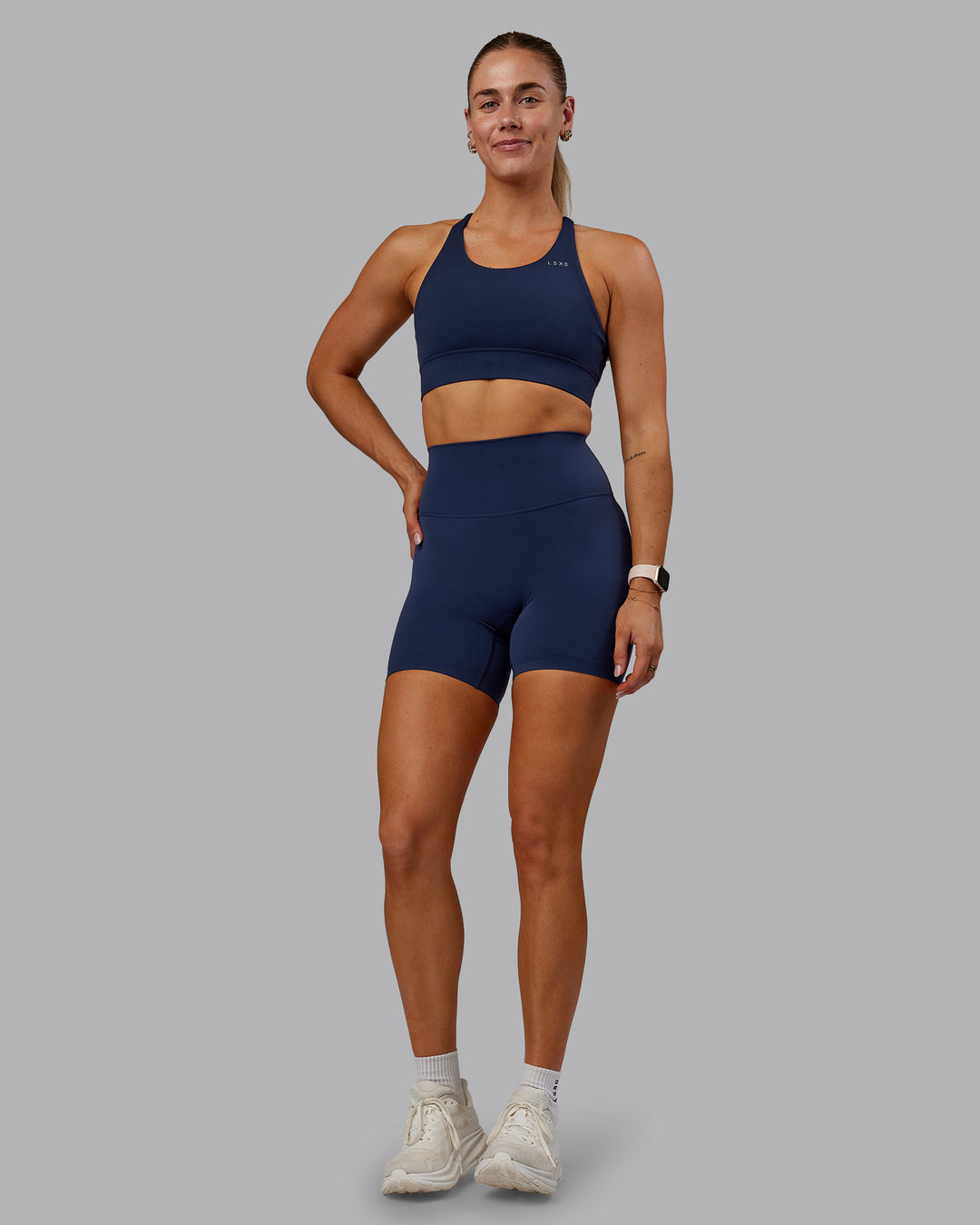 Woman wearing Accelerate Sports Bra - Future Navy