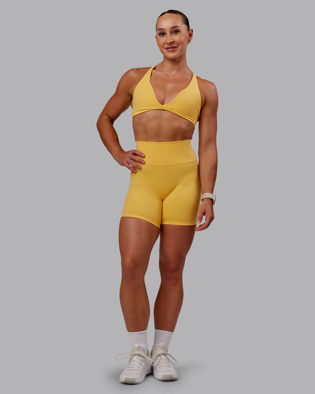 Woman wearing Agile Sports Bra in Banana Cream | Size:S