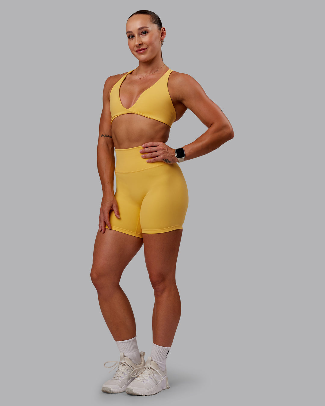 Woman wearing Agile Sports Bra in Banana Cream | Size:S