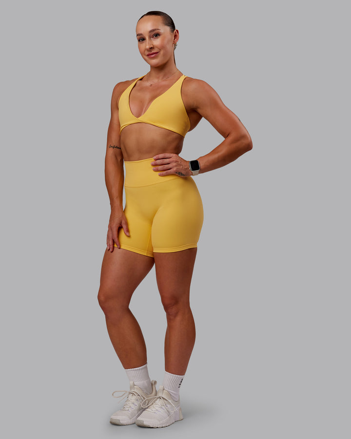 Woman wearing Agile Sports Bra in Banana Cream | Size:S
