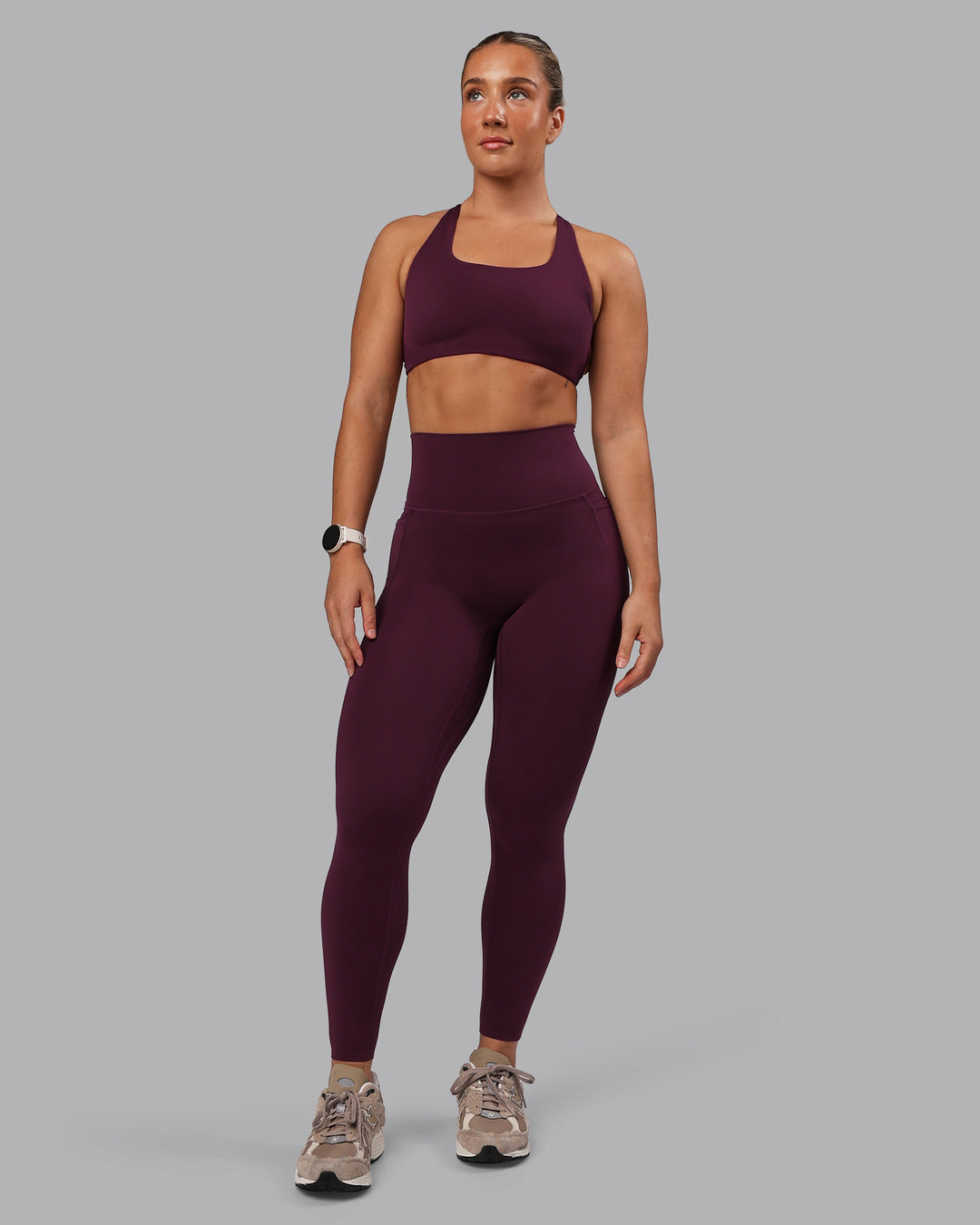 Woman wearing Aspire Sports Bra - Cherry Lacquer