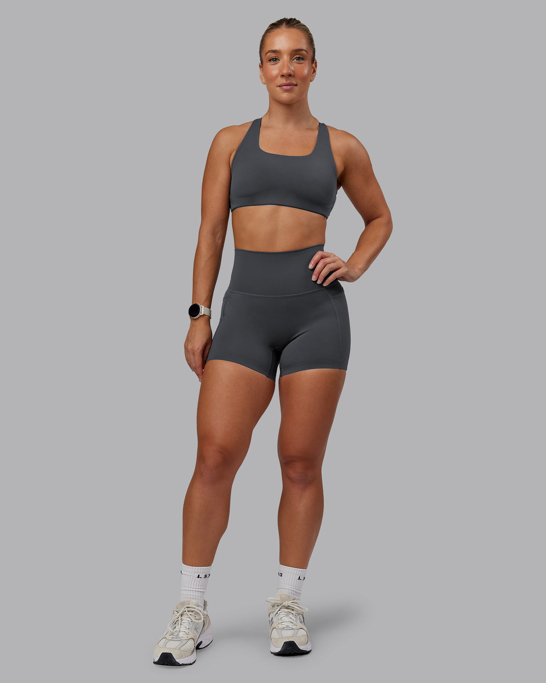 Woman wearing Aspire Sports Bra in Dark Storm | Size:S