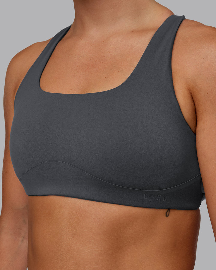 Woman wearing Aspire Sports Bra in Dark Storm | Size:S
