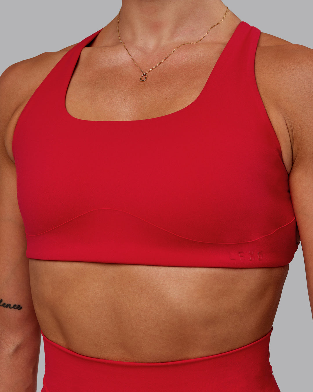 Woman wearing Aspire Sports Bra in Flame | Size:S