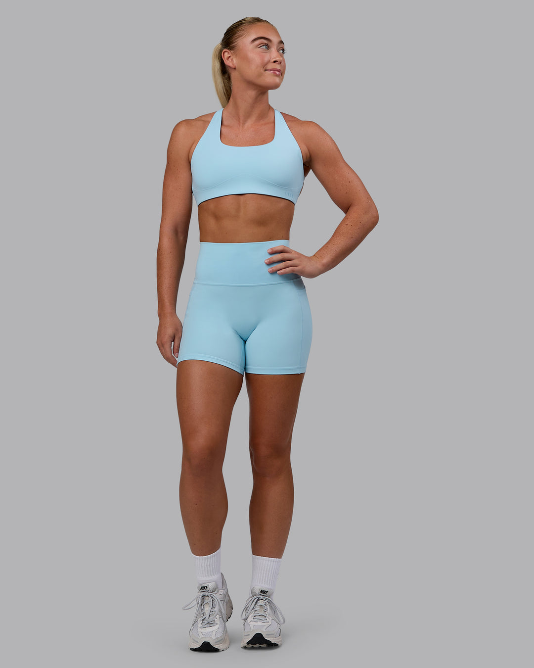 Woman wearing Aspire Sports Bra - Glacial Blue