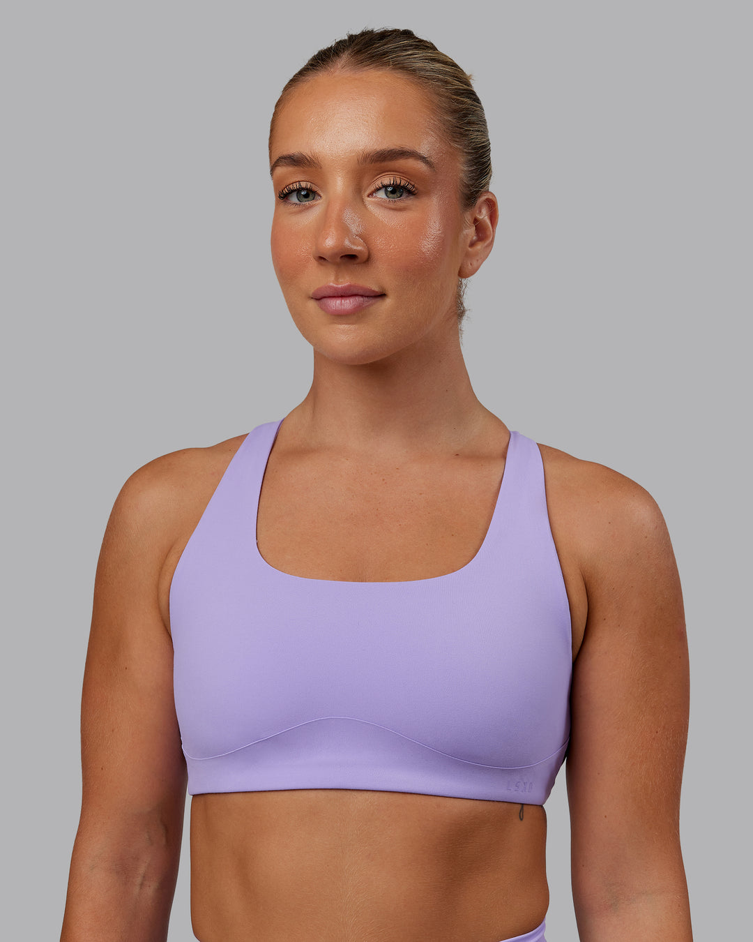 Woman wearing Aspire Sports Bra in Violet Ray | Size:S