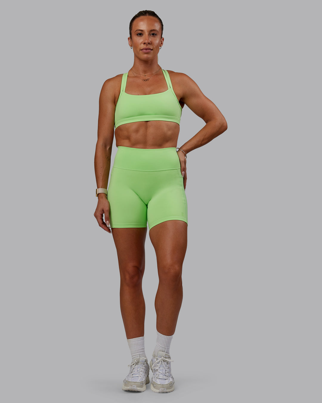 Woman wearing Bree Masters Fusion Mid Short Tights with Pockets - Pastel Lime