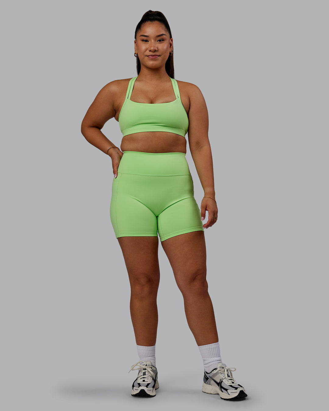 Woman wearing Bree Masters Fusion Mid Short Tights with Pockets - Pastel Lime