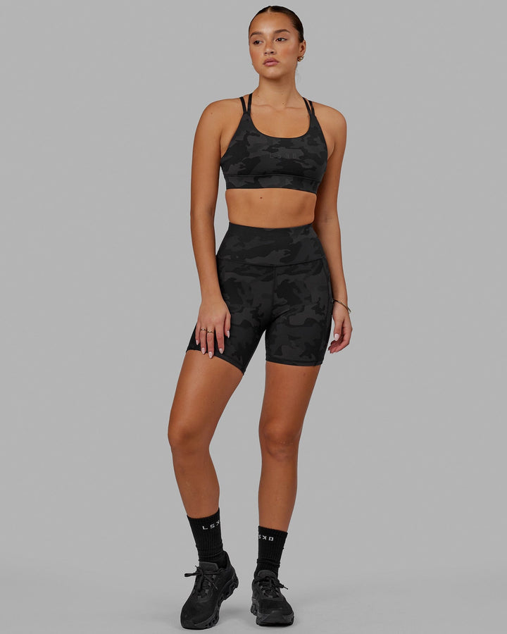 Woman wearing Bridge Sports Bra - Black Camo
