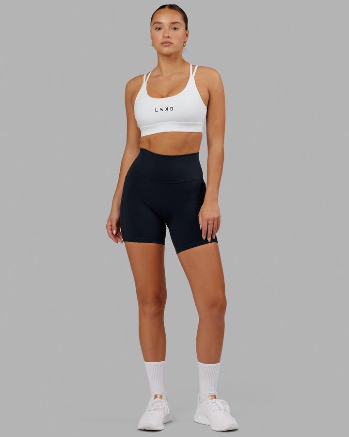 Woman wearing Bridge Sports Bra - White
