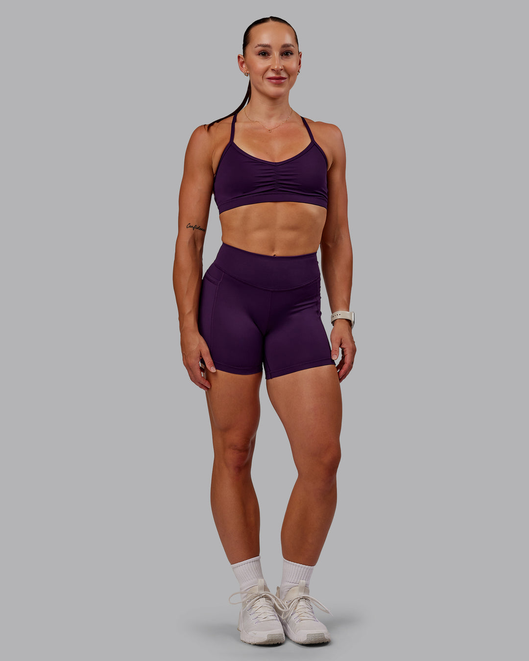 Woman wearing Clarity Sports Bra in Deep Purple | Size:S